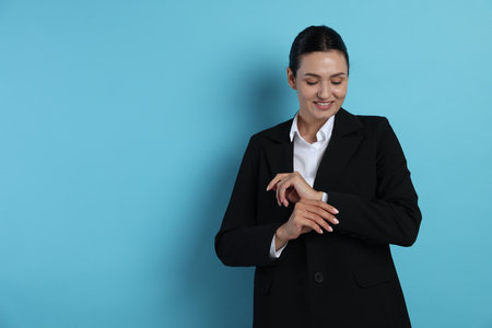Confident business woman in suit on light blue background. Space for textの写真素材