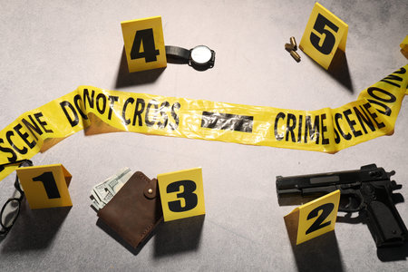 Forensic expertise. Crime scene with evidence, markers and police tape on light gray backgroundの写真素材