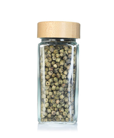 Green peppercorns in spice jar isolated on white