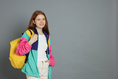 Portrait of teenage girl on grey background. Space for textの写真素材