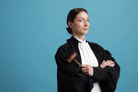 Judge with mallet on light blue background, space for textの写真素材