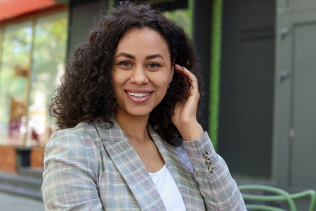 Portrait of smiling Latin American woman outdoorsの写真素材