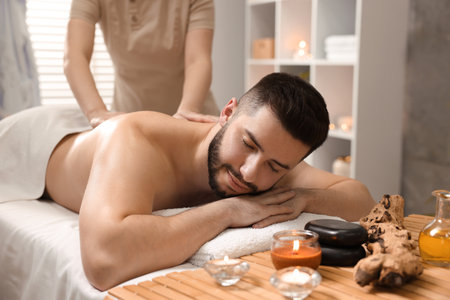 Man receiving relaxing massage in spa salonの写真素材