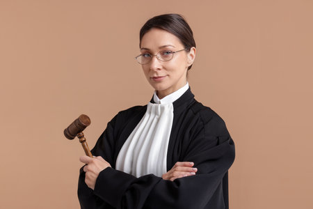 Judge with mallet on light brown backgroundの写真素材