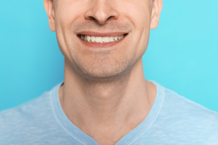 Smiling man after shaving on light blue background, closeupの写真素材