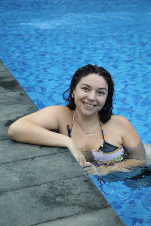 Happy woman relaxing in swimming pool outdoors