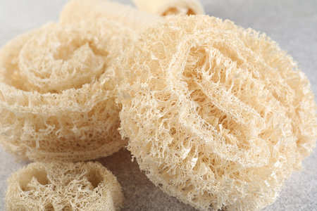 Different loofah sponges on light gray table, closeupの写真素材