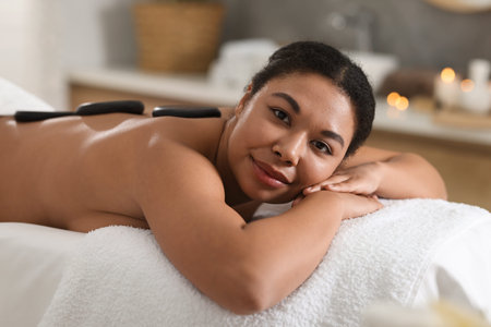 Beautiful woman relaxing on massage couch in spa salon