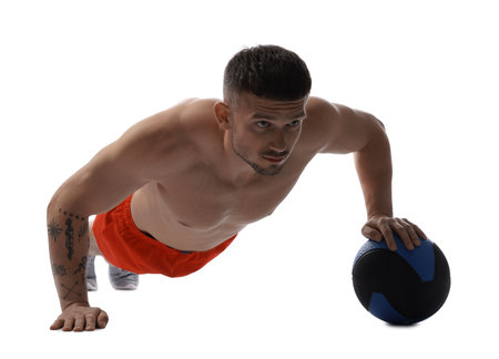 Man exercising with medicine ball on white backgroundの写真素材