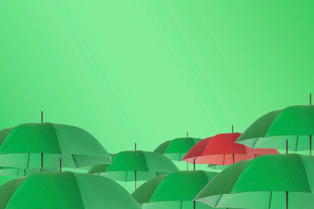 Red umbrella among yellow green against color backgroundの写真素材