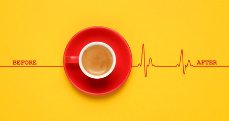 Cup of coffee and heartbeat line on yellow background, top view. Calm pulse becoming active. Invigorating properties of caffeine, healthcareの写真素材