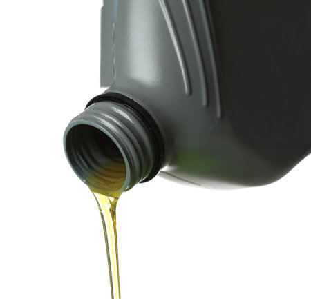 Pouring motor oil from grey canister isolated on whiteの写真素材