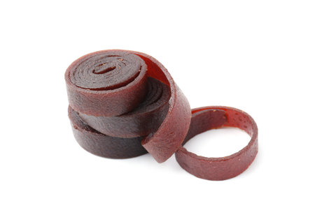 Delicious fruit leather rolls on white background