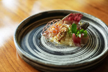 Tasty burrata ham salad served on wooden table, closeupの写真素材
