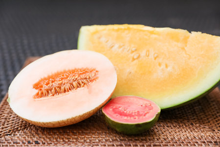 Ripe juicy tropical fruits on wicker table, closeupの写真素材