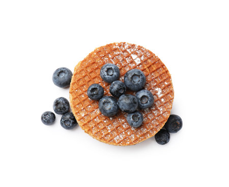Tasty Dutch waffles (stroopwafels) and blueberries isolated on white, top viewの写真素材