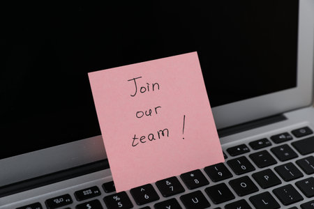 Sticky note with phrase Join Our Team on laptop, closeupの写真素材