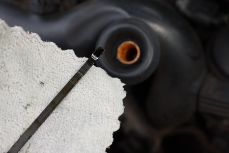 Checking motor oil level. Dipstick and rag near car engine, closeupの写真素材