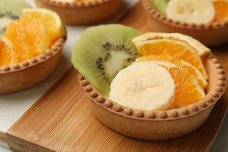 Tartlets with fruits on table, closeup. Delicious dessertの写真素材