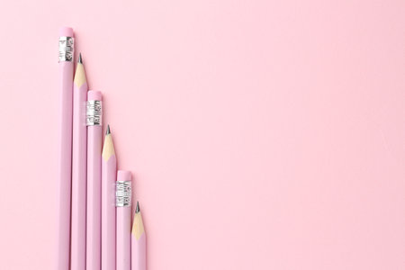 Many graphite pencils on pink background, flat lay. Space for textの写真素材