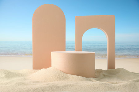 Podium for product presentation. Figures on sand near blue sea. Stylish promotion posterの写真素材