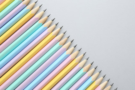 Many graphite pencils on light gray background, flat lay. Space for textの写真素材