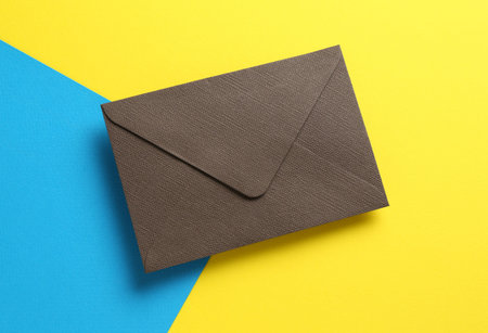 Beautiful invitation envelope on color background, top viewの写真素材