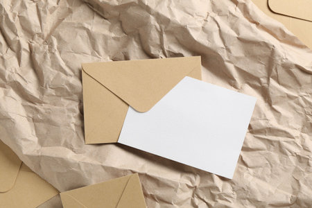 Blank invitation card and envelopes on parchment paper, flat lay. Space for designの写真素材
