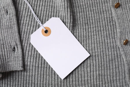 Cardboard tag on gray garment, top viewの写真素材