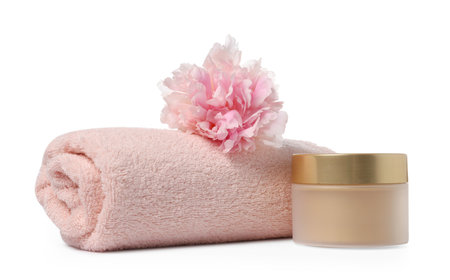 Soft towel, cosmetic product and peony flower isolated on whiteの写真素材