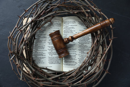 Judge's gavel, crown of thorns and Bible on black table, top viewの写真素材