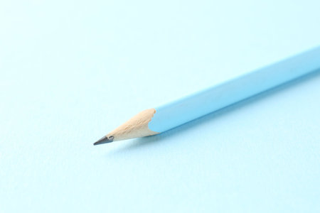 One graphite pencil on light blue background, closeupの写真素材