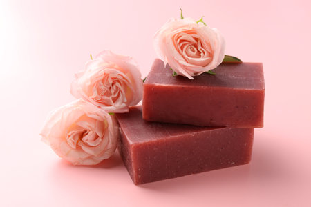 Soap bars and beautiful roses on pink background, closeupの写真素材