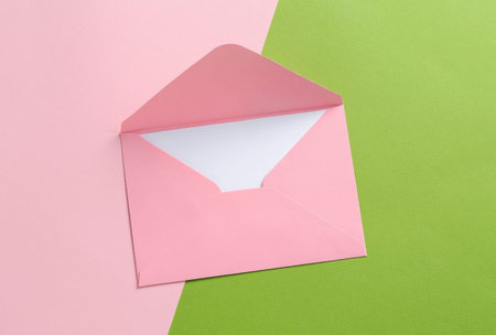 Blank invitation card and envelope on color background, top view