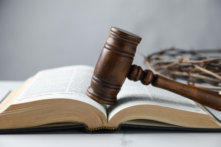 Judge's gavel, Bible and crown of thorns on white marble table, closeupの写真素材