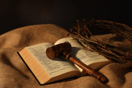 Judge's gavel, Bible and crown of thorns on burlap fabric