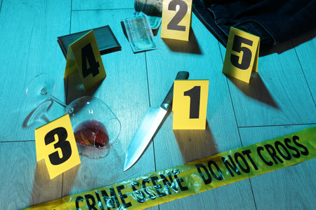 Forensic expertise. Crime scene with evidence, markers and police tape on floor. Color toned effectの写真素材