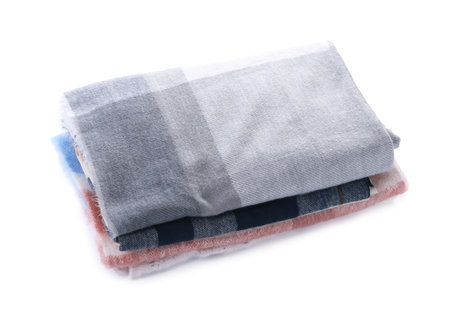 Stack of stylish wool scarves isolated on white