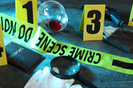 Forensic expert. Yellow crime scene tape, markers and evidences on gray table, closeupの写真素材