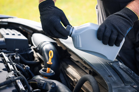 Worker checking motor oil level in car with dipstick, closeupの写真素材