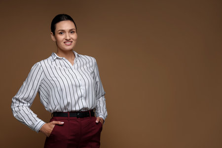 Portrait of confident business woman on brown background. Space for textの写真素材