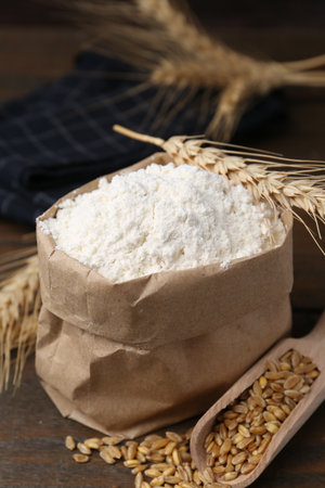 Wheat flour, grain and spikes on wooden table, closeupの写真素材