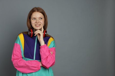 Portrait of teenage girl on grey background. Space for text