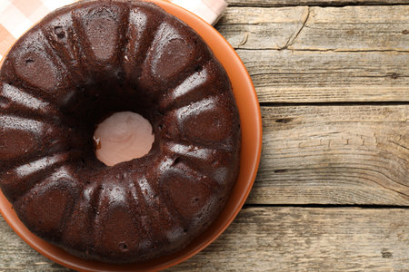 Tasty chocolate bundt cake on wooden table, top view. Space for textの写真素材