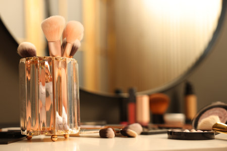 Different makeup products and brushes on dressing table indoors, closeupの写真素材