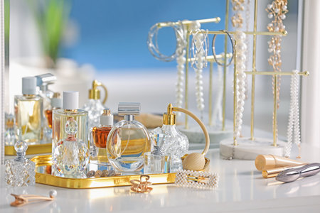 Bottles of different perfumes and accessories on table indoorsの写真素材