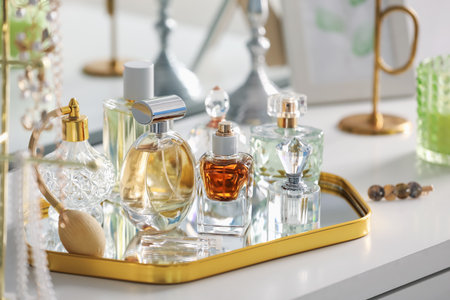 Bottles of different perfumes on white table indoors, closeupの写真素材