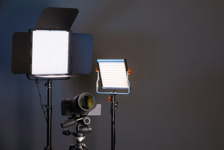 Professional lighting equipment and camera on color background. Space for textの写真素材