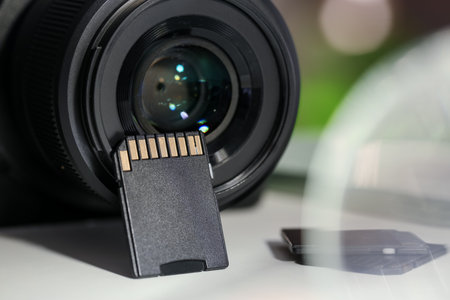 SD memory cards and photo camera on white table, closeupの写真素材
