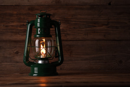 One vintage kerosene lantern on wooden table, space for textの写真素材